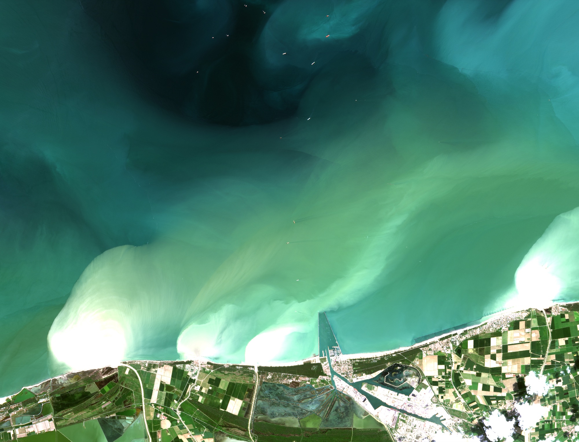 Bright sediment plumes fanning out from the four river mouths, 4 May 2023
